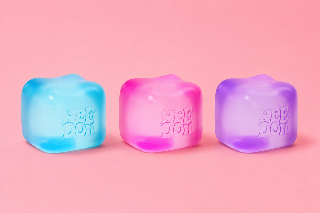 Pastel NeeDoh squishy cubes in blue pink and purple on pink background